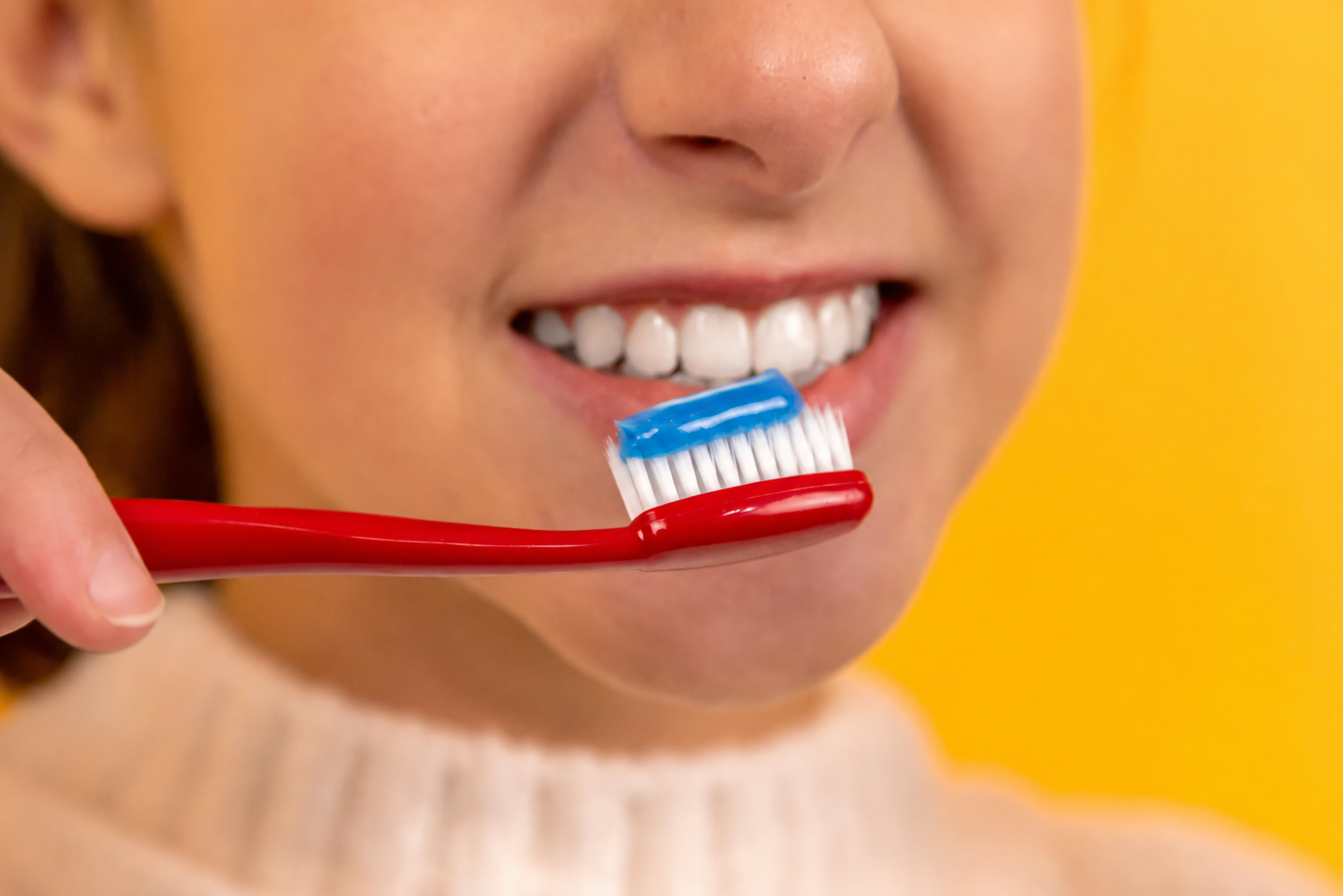 Toothbrush and healthy smile representing preventive oral care